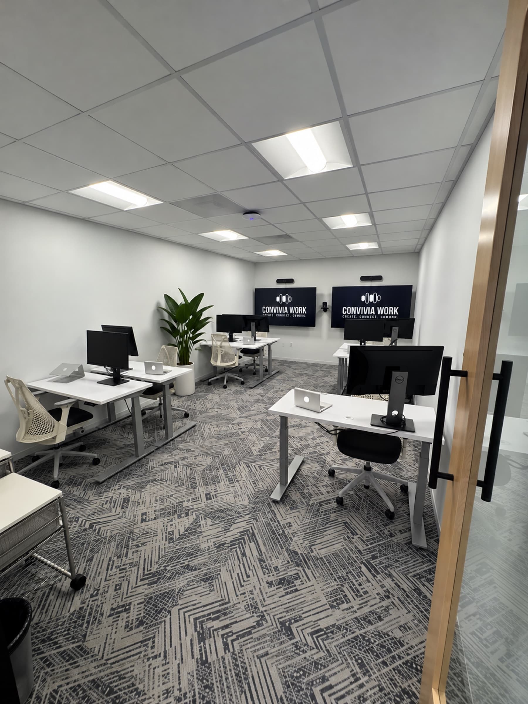 New Team Suite with seven desks and two TV screens